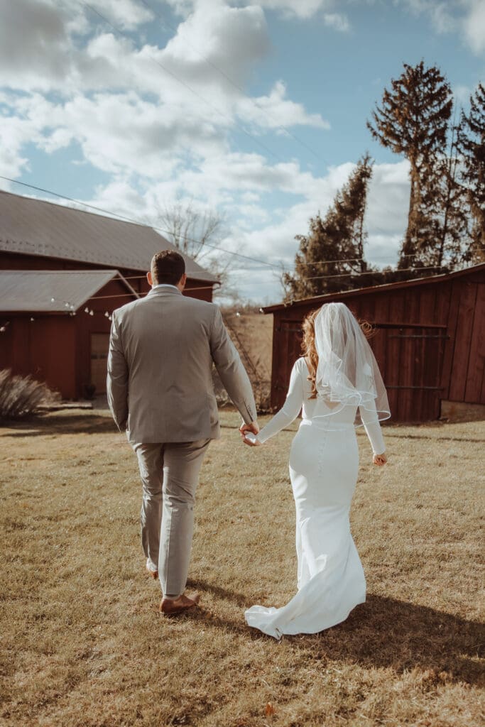 Bride and groom walk to their reception at Maple Valley Farm in berks county. 