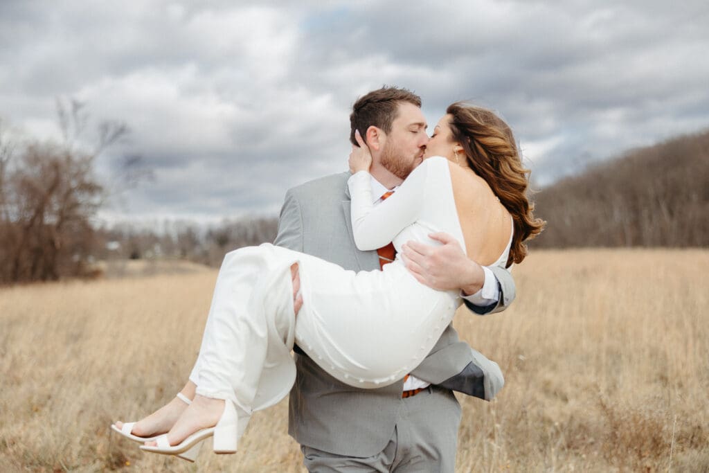 Windy wedding day couple poses. 