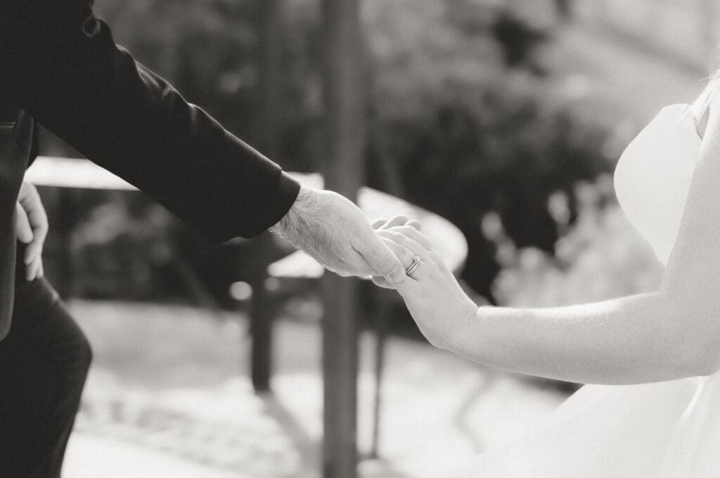 Bride and groom hold hands at the wedding alter at Folino Estate winery in Kutztown PA, a berks county wedding venue.